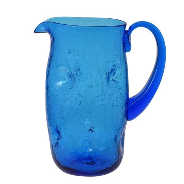 Blue glass dimpled pitcher for dining room decorated with vine pattern linens