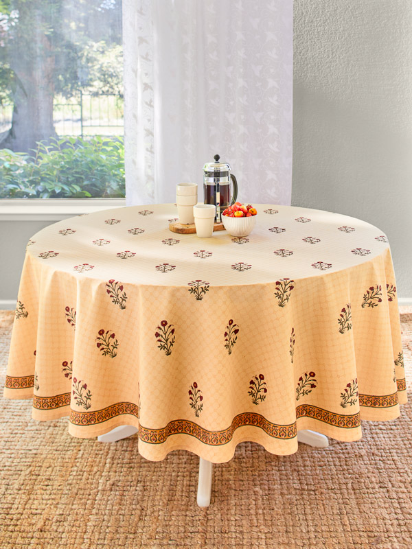 red floral pattern table runner with French press coffee and cups in a sunny dining room