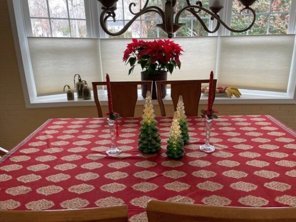 boho Christmas tablecloth in red with glass tree centerpiece and poinsettias