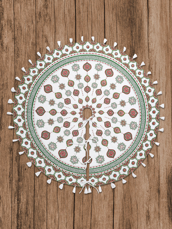 Photograph of a red, green, and white Christmas tree skirt on a wooden ground