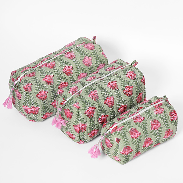 Photograph of a cosmetic bag set showcasing a pink and green floral tulip pattern on a soft green ground