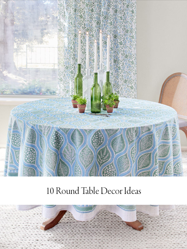 Photograph of a table covered in a blue and sage green tablecloth with decor on top and a banner below that reads "10 Round Table Decor Ideas"