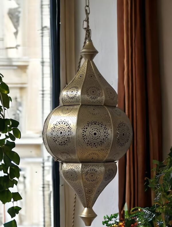 Photograph of a Moroccan style hanging lantern to support round table decor ideas using themed lighting