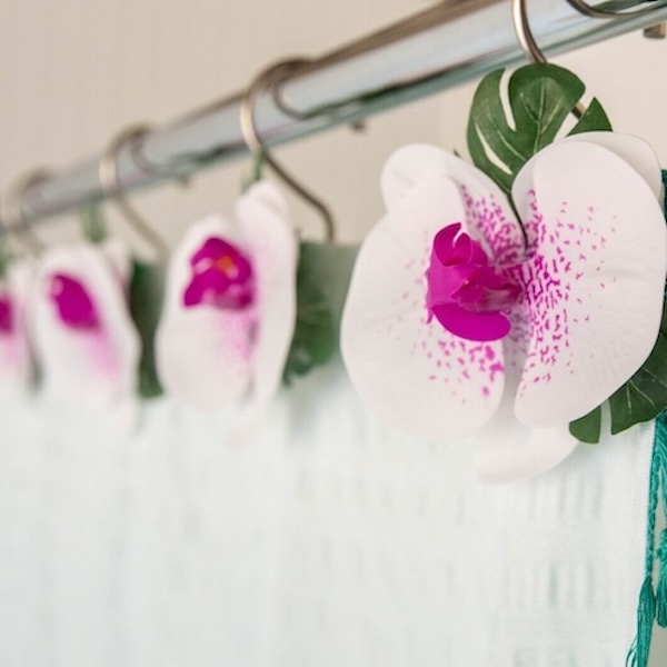 Photograph of orchid shower curtain ring decor for a beach themed bathroom