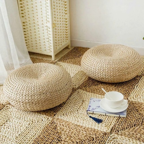 Photograph of a rattan tatami cushion to demonstrate fall living room decor that goes with white farmhouse curtains