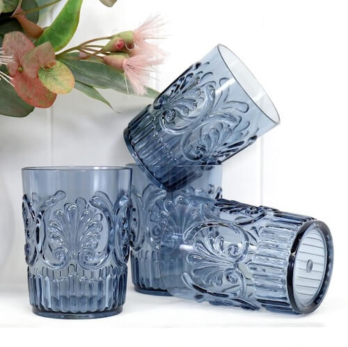 Denim blue glassware for rustic table decor using sunflower print table cloth.