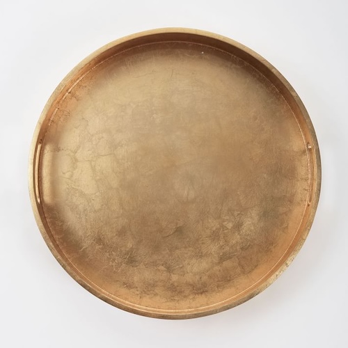 Wooden round tray with gold lacquer to demonstrate glamorous home decor for the living room