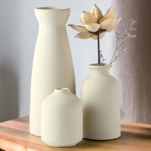 Set of three matte white vases in different shapes and sizes to complement a Modern Rustic living room.