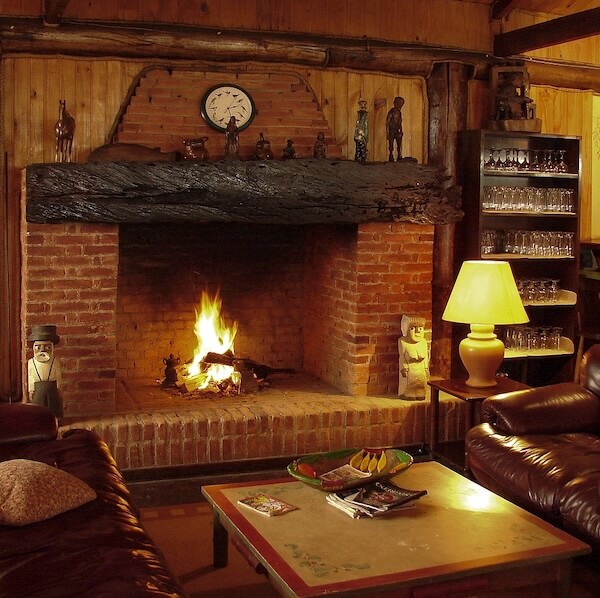 Cabin decor ideas including fireplace, wooden mantel, and hand-carved wooden accents