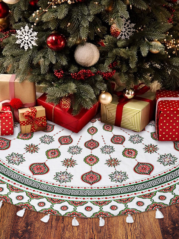 Christmas tree skirt under tree and gift boxes wrapped in festive paper