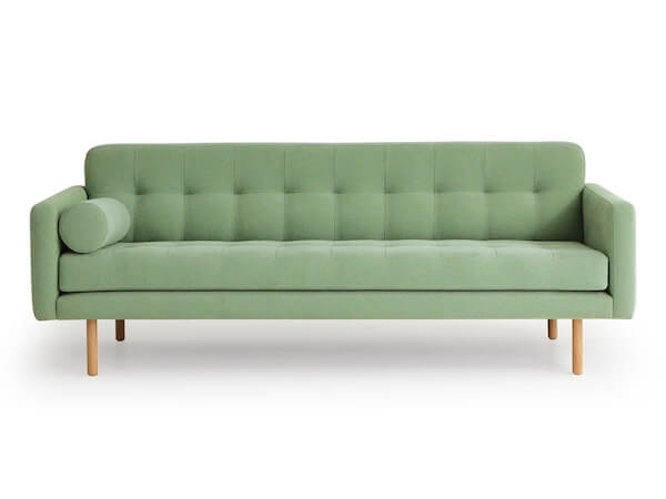 Long, sleek, statement couch as part of a list of narrow living room ideas