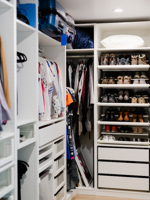 Walk-in closet with shelves and hanging space in a blog for spare room ideas